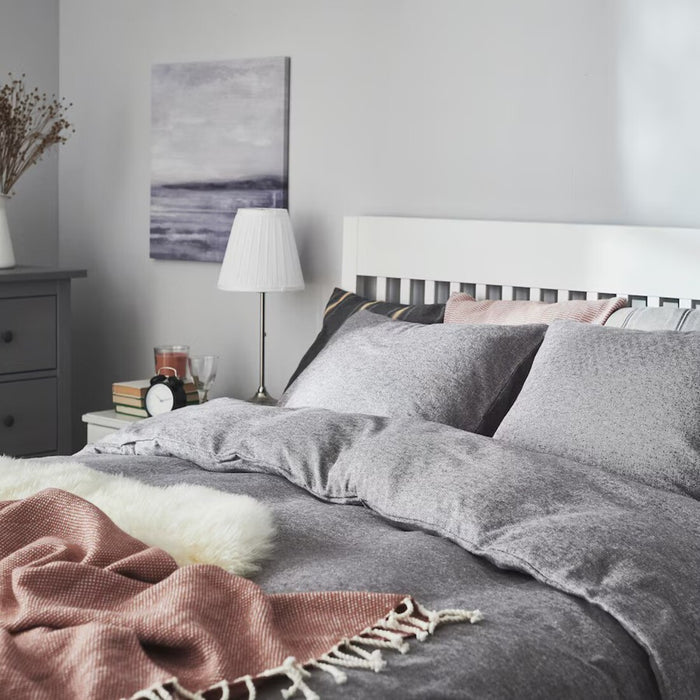 IKEA VÄSTKUSTROS duvet cover and pillowcase set in dark grey and white, displayed on a neatly made bed-90500611