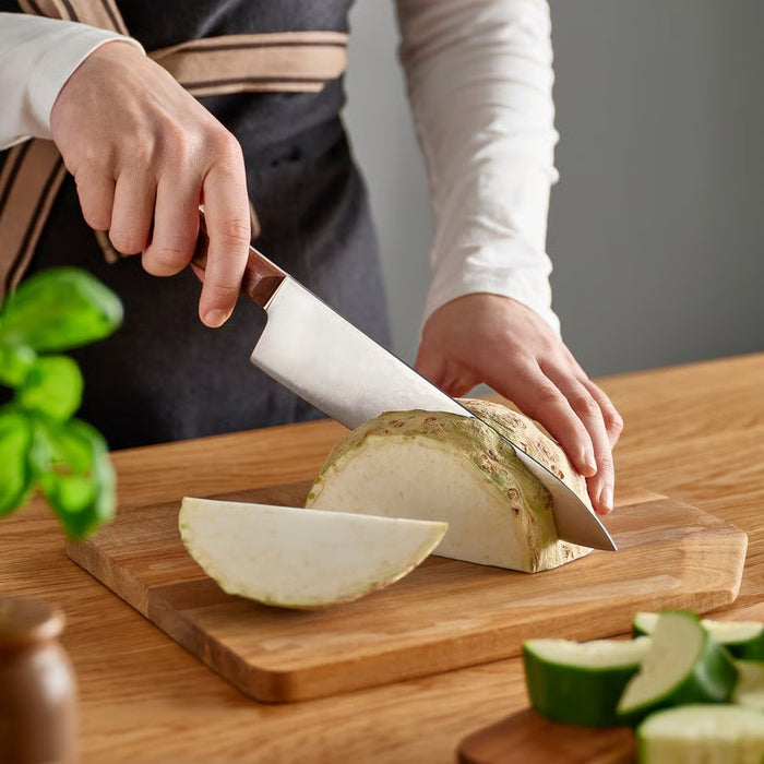 Scandinavian-designed IKEA VARDAGEN 8-inch cook's knife (model 806.024.79) featuring durable stainless steel construction with natural walnut handle for professional food preparation.