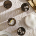  Four IKEA VARDAGEN brown tempered glasses filled with ice cubes on a tablecloth