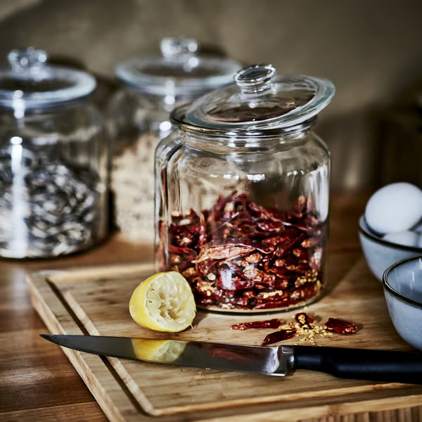 IKEA VARDAGEN glass jar with lid styled with dried chilies and lemon on wooden cutting board