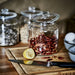 IKEA VARDAGEN glass jar with lid styled with dried chilies and lemon on wooden cutting board