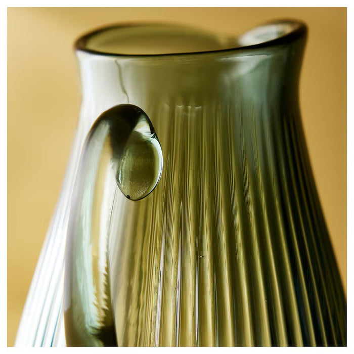 "Close-up of the IKEA VARDAGEN jug featuring a textured, dark grey-green finish and classic shape.-00576653
