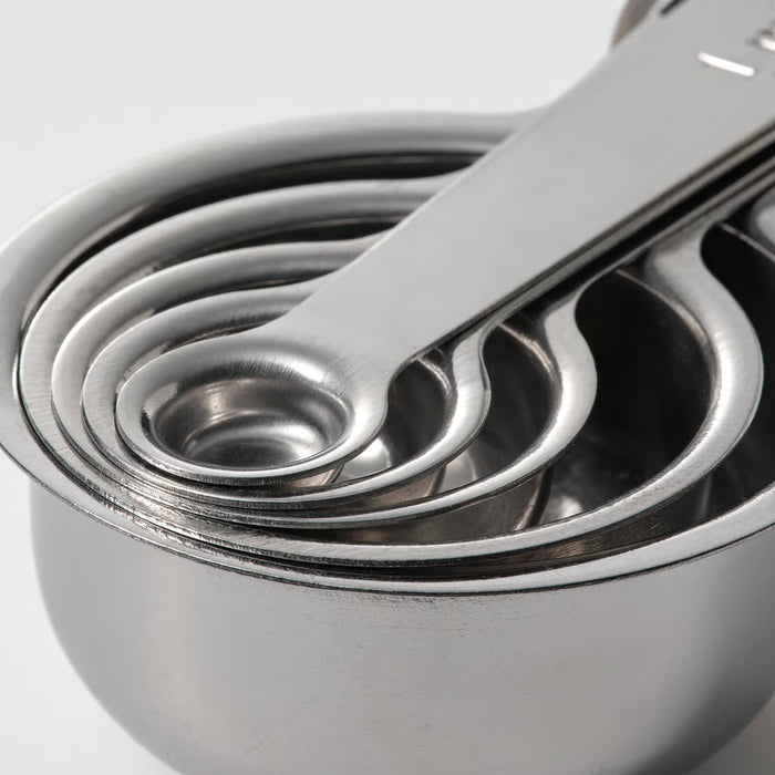 Five IKEA VARDAGEN stainless steel measuring cups fully nested clean and polished side view