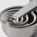 Five IKEA VARDAGEN stainless steel measuring cups fully nested clean and polished side view