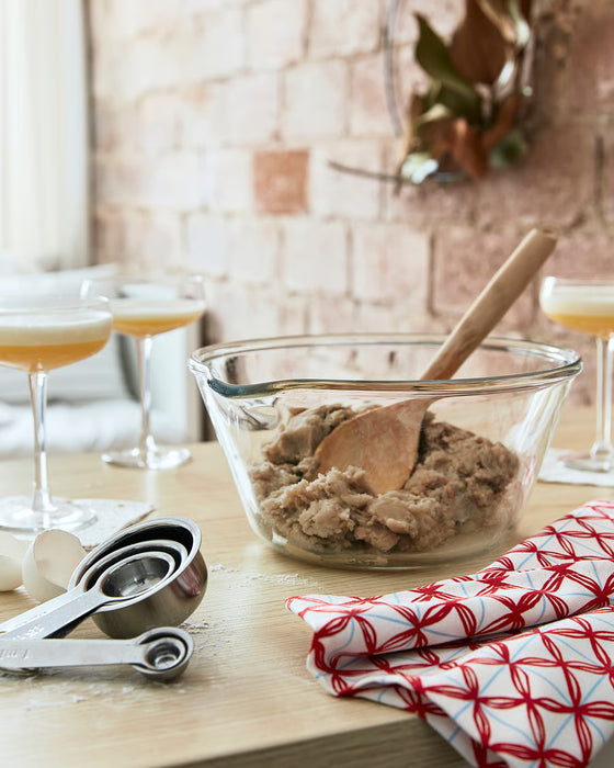 IKEA VARDAGEN measuring cups on kitchen worktop alongside mixing bowl dough and wooden spoon