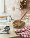 IKEA VARDAGEN measuring cups on kitchen worktop alongside mixing bowl dough and wooden spoon