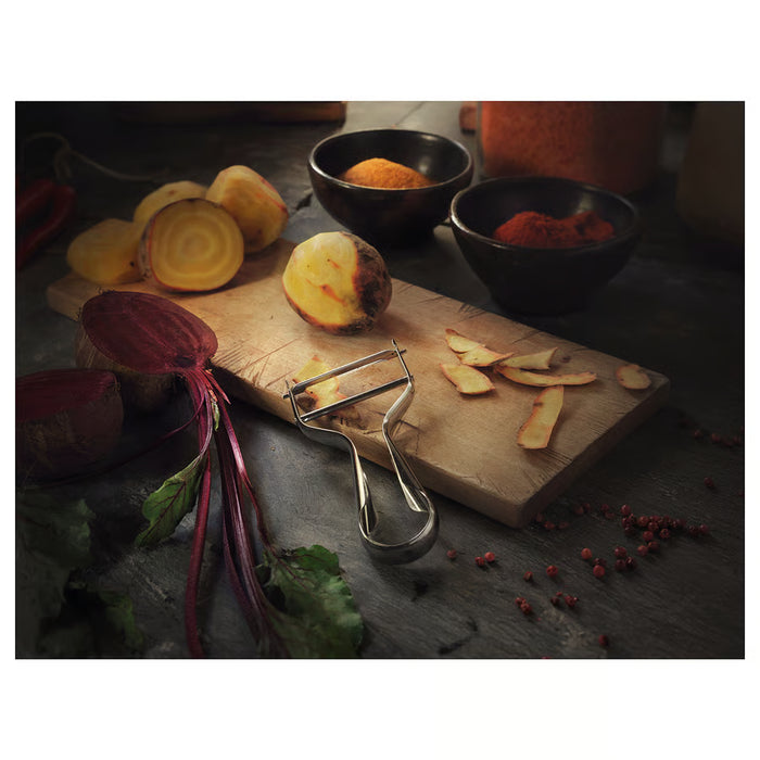 IKEA VARDAGEN peeler on wooden board with sliced vegetables and spices styled kitchen setting