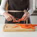 Person peeling carrots with IKEA VARDAGEN peeler on wooden chopping board kitchen use