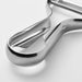 Close-up of IKEA VARDAGEN stainless steel peeler reflecting light showing blade and handle detail
