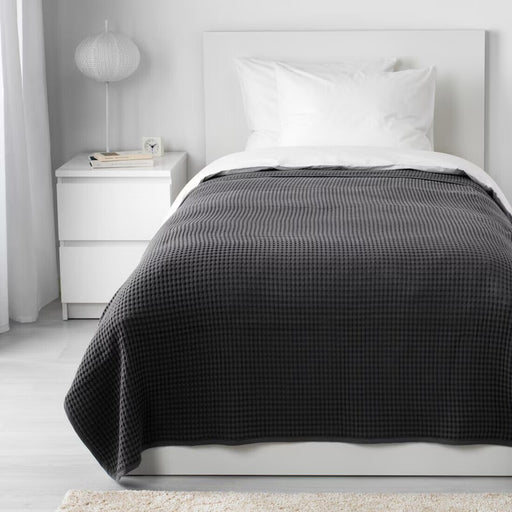 Dark grey IKEA VÅRELD Bedspread on a bed, adding a modern touch to the bedroom decor-80346446