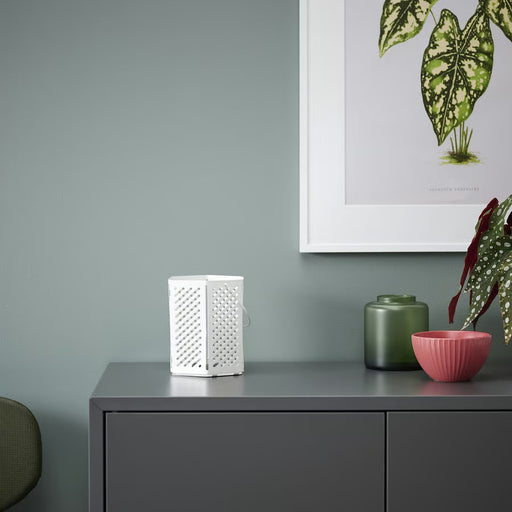 IKEA VÅRSYREN white lantern on grey cabinet casting shadows against blue wall