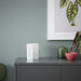 IKEA VÅRSYREN white lantern on grey cabinet casting shadows against blue wall