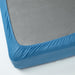Neatly made bed with IKEA VÅRVIAL blue fitted sheet and white pillows, smooth fit