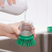 Refilling IKEA VIDEVECKMAL green dish brush dispenser with washing-up liquid from above