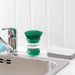 Kitchen sink styled with IKEA VIDEVECKMAL green dish brush, soap dispenser, and sponge alongside