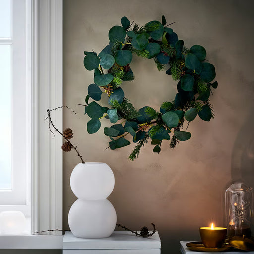 IKEA VINTERFINT eucalyptus wreath hung on door, indoor outdoor festive decor