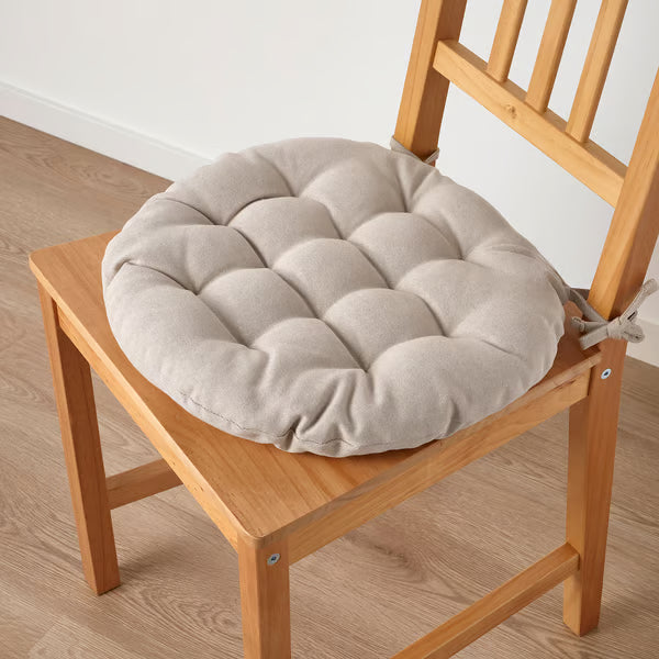 IKEA VIPPÄRT beige chair pad tied securely on wooden chair, side angle showing 6.5cm thickness