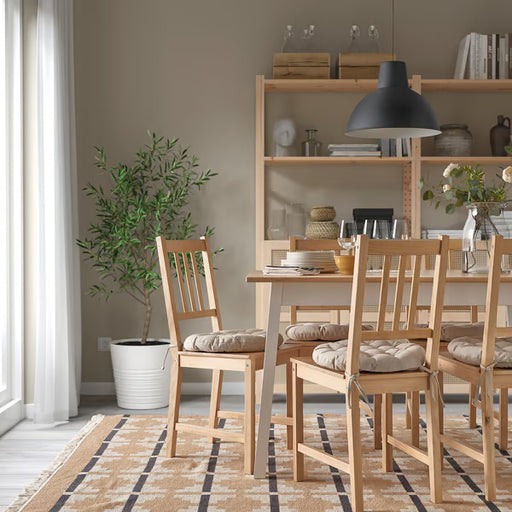 IKEA VIPPÄRT beige chair pads styled on dining chairs in cosy room with pendant light and plant