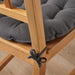 Close-up of IKEA VIPPÄRT chair pad tied to wooden chair leg for secure fit