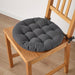 IKEA VIPPÄRT dark grey chair pads on wooden dining chairs in cosy home setting