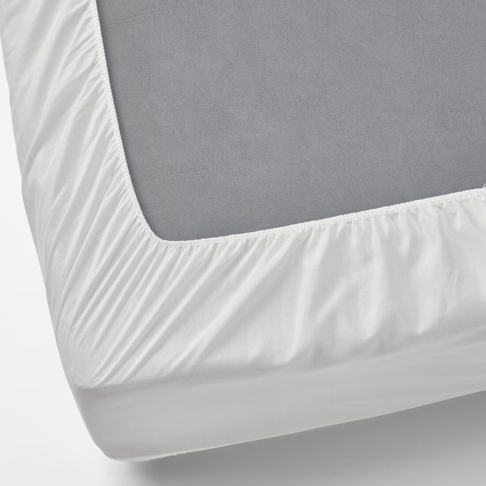 White fitted IKEA VIPPVEDEL mattress protector covering a gray mattress. Features elastic edges for a snug fit, quilted design for added comfort, and durable fabric for protection against dust and stains.