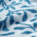 Close-up of IKEA VITBACKEN cotton terry bath towel showing blue leaf pattern and soft weave
