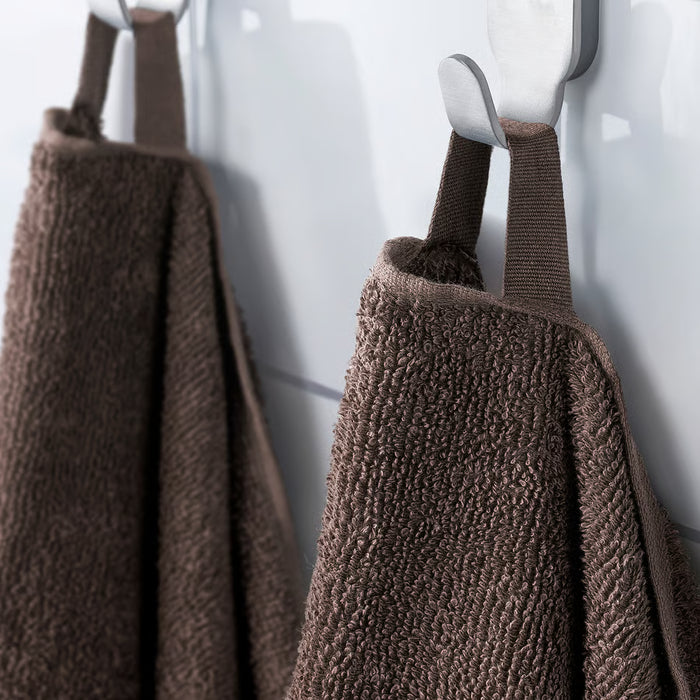 IKEA VITBACKEN brown bath towels on silver hooks, one looped through its corner for easy hanging