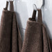 IKEA VITBACKEN brown bath towels on silver hooks, one looped through its corner for easy hanging