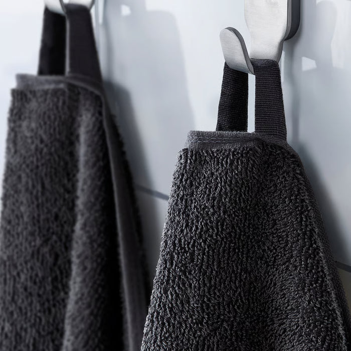 IKEA VITBACKEN grey bath towels hanging on hooks using their loops for easy hanging