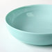 IKEA VITBLECKA turquoise plate styled with food on a minimal table arrangement