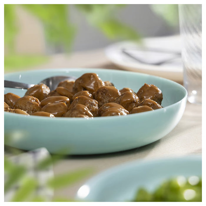 Close-up of IKEA VITBLECKA turquoise opal glass plate showing texture and colour detail