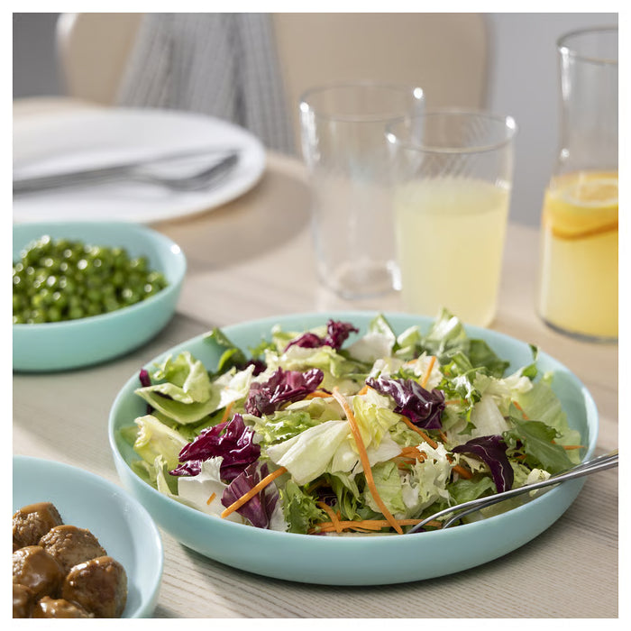 IKEA VITBLECKA turquoise plate styled on a dining table with food serving