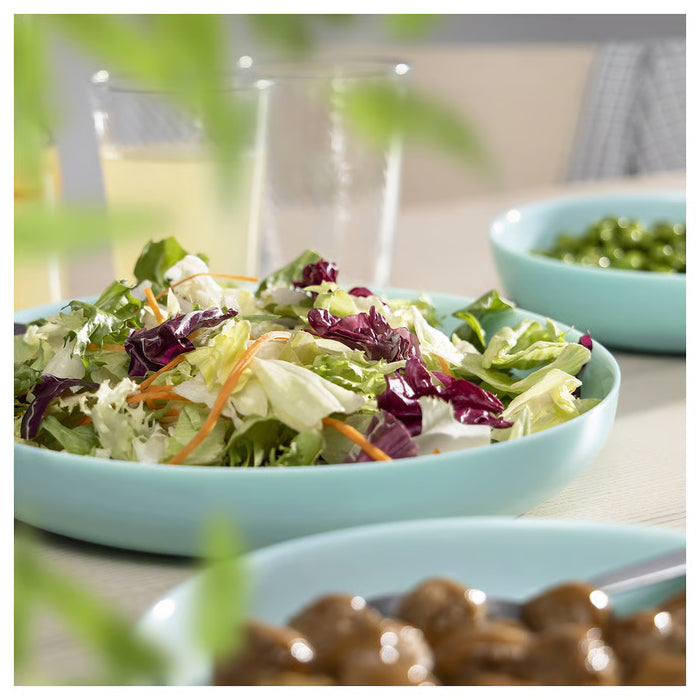 Close-up of IKEA VITBLECKA turquoise plate rim showing bone porcelain-like opal glass texture