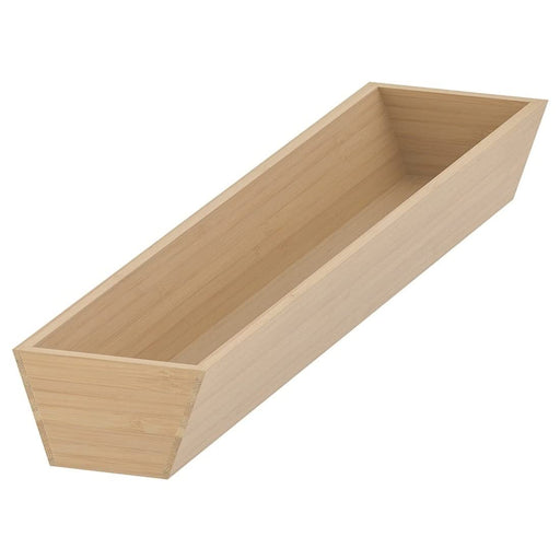 A light bamboo IKEA utensil tray, with various kitchen utensils neatly arranged inside.