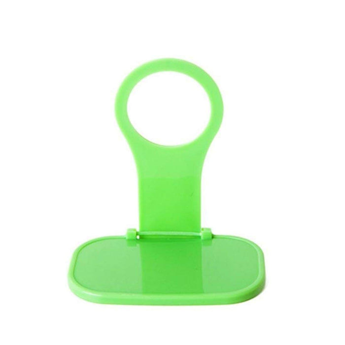 Foldable green mobile phone charging holder on white background
