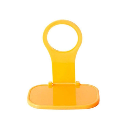 Foldable yellow mobile phone charging holder on white background