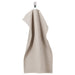 A dark beige hand towel from the Ikea 6 Piece Combo Set, hanging on a silver towel bar next to a white sink.