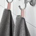 A close-up image of a folded Grey hand towel with a textured pattern 90512874