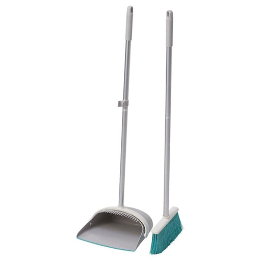 Ergonomic Design: a person using the IKEA dustpan and broom set, with a focus on the comfortable grip and angled handle of the broom.