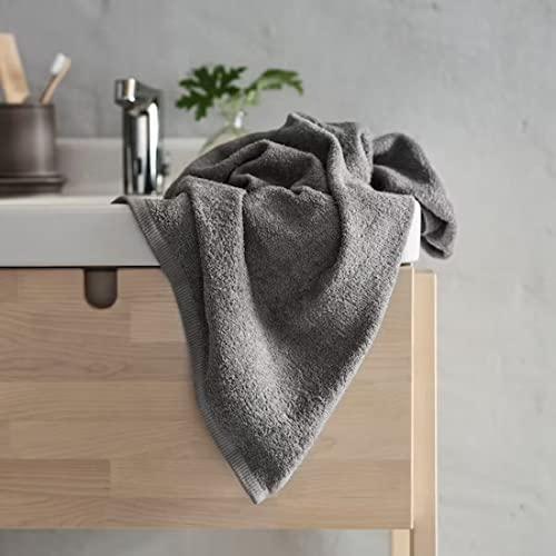 A folded grey bath towel from the Ikea 6 Piece Combo Set, sitting on a wooden bathroom stool.