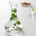 A clear glass carafe with a timeless design, perfect for any occasion and decor style.