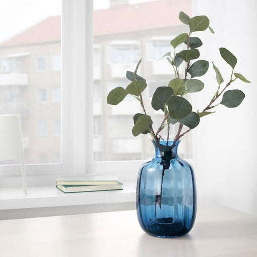 Blue glass plant vase with a delicate and translucent texture, designed for showcasing delicate flowers and blooms in style. 10442192