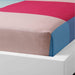 Multicolor cotton flat sheet and pillowcase set from IKEA draped on a bed 70427589