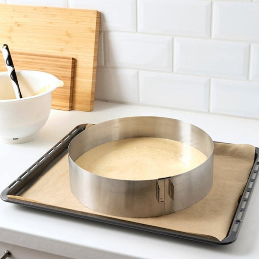 The IKEA Baking Frame, Adjustable, in use in a busy kitchen, with multiple baked goods being prepared at once.