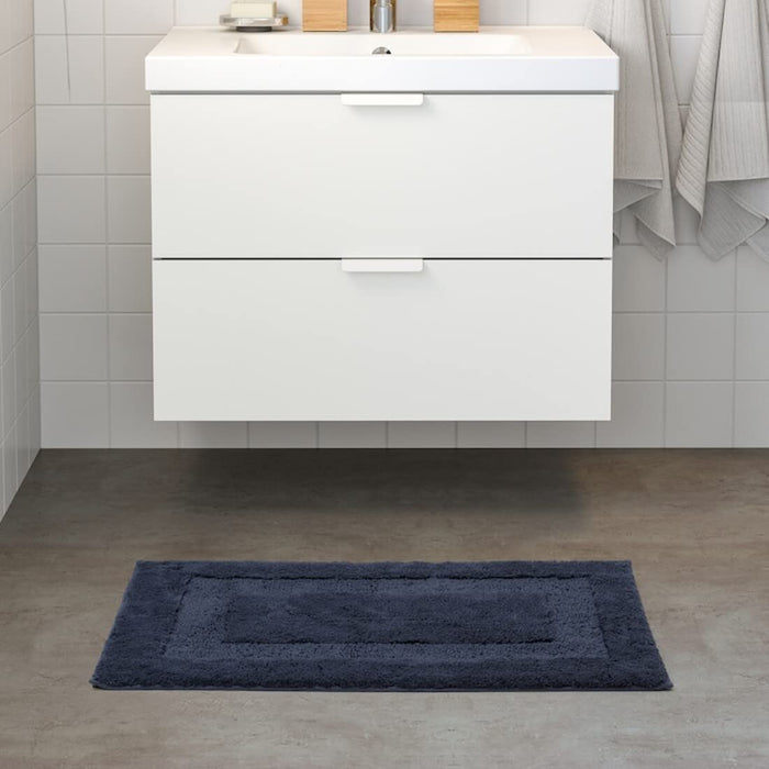  IKEA bath mat placed on a bathroom floor, featuring a soft and absorbent texture and a non-slip bottom for secure footing 50500137