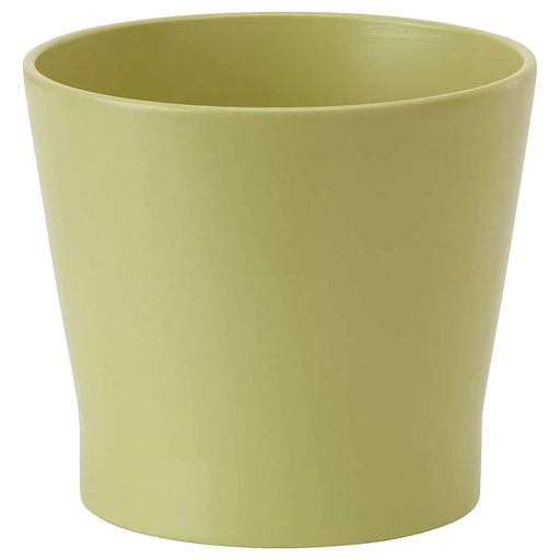 A round plant pot with a glossy finish and a slight curve at the edges, containing a cluster of colorful flowers.