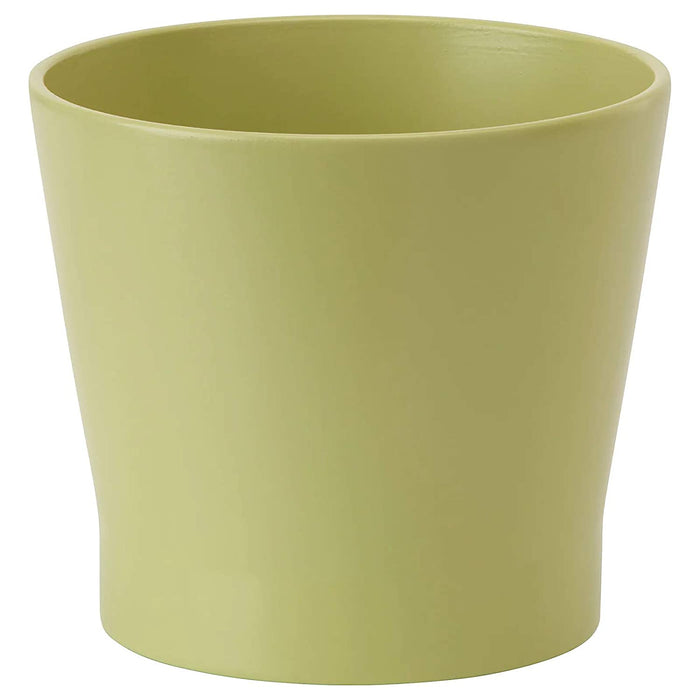A round plant pot with a glossy finish and a slight curve at the edges, containing a cluster of colorful flowers.