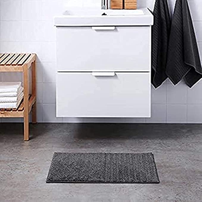 Dark grey IKEA bath mat placed on a bathroom floor, featuring a soft and absorbent texture and a non-slip bottom for secure footing 10447279