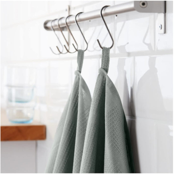 A grey Ikea hand towel with fringed edges hanging on a hook 60219821