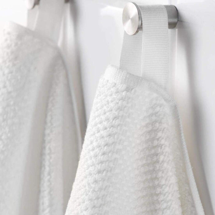 A close-up image of a folded white hand towel with a textured pattern70168468